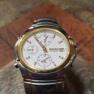 Seiko Chronograph Watch with Gold Bezel and Silver Band